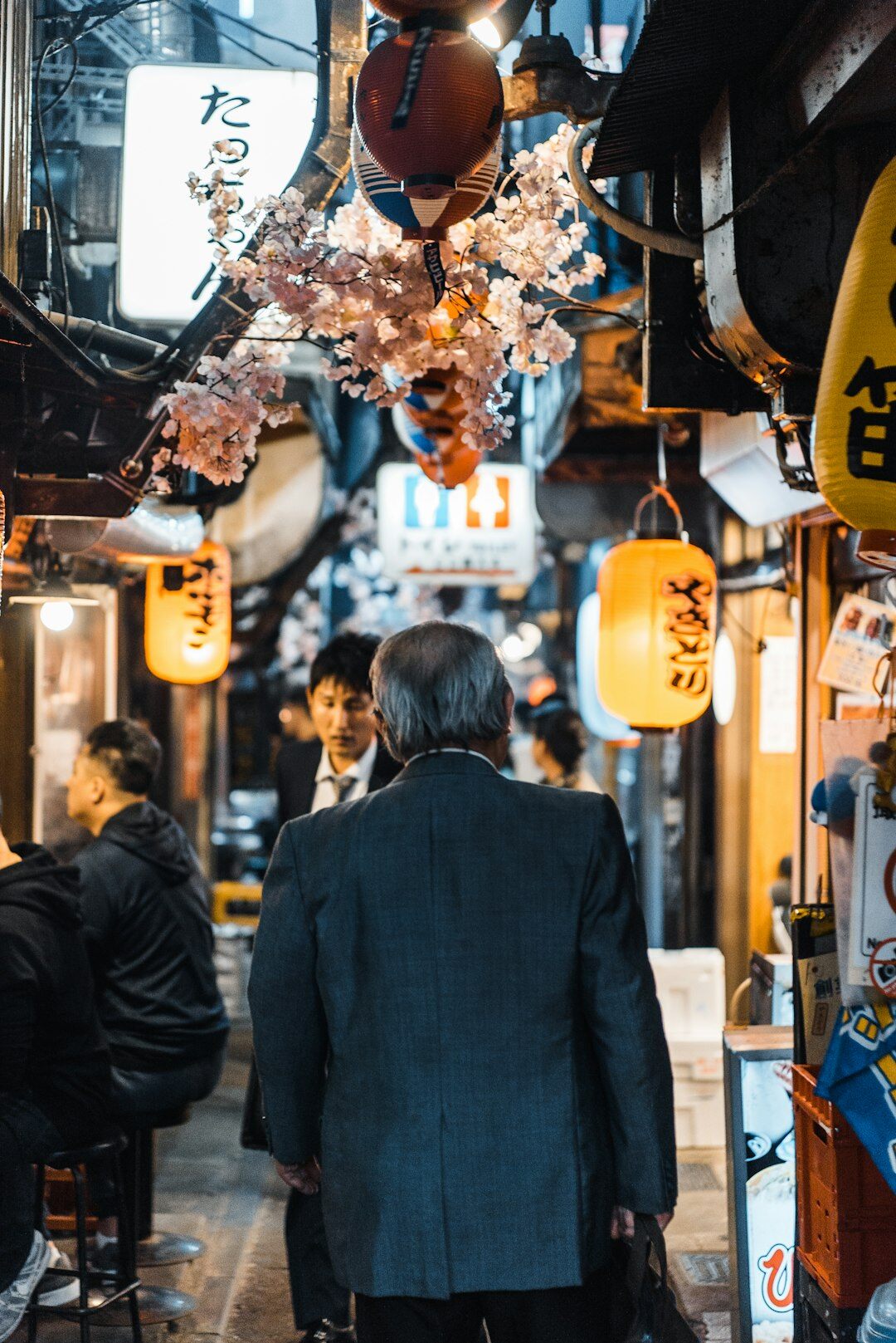 Japanese man in a dark suit jacket looking at camera