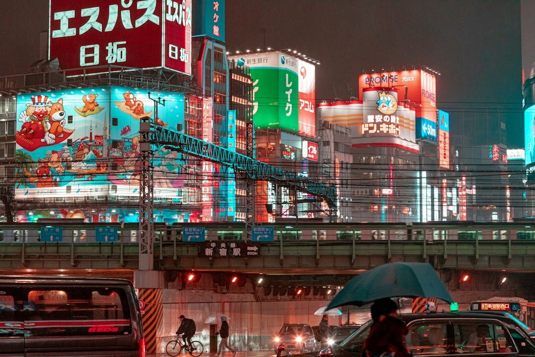 Crowded Tokyo street at night with bright neon lights